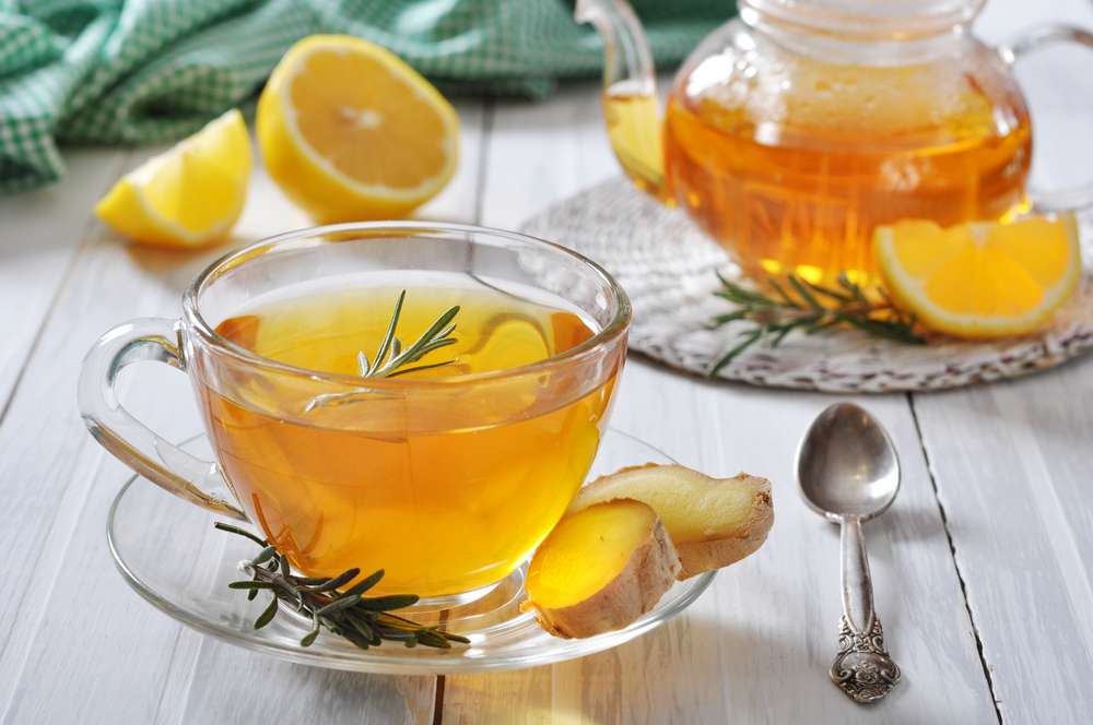 wholesale tea suppliers. Image of a glass tea pot and glass with herbal tea and lemons.